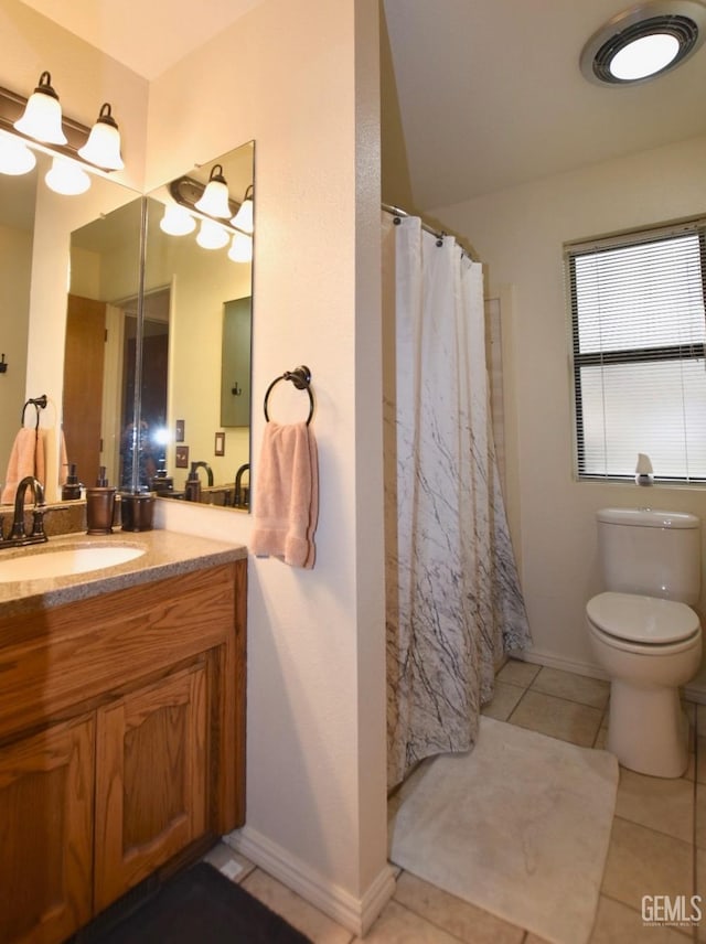 bathroom with tile patterned flooring, vanity, and toilet