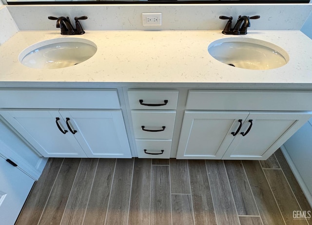 2411 Addlington St, Bakersfield, CA 93311 - bathroom with wood finished floors and double vanity