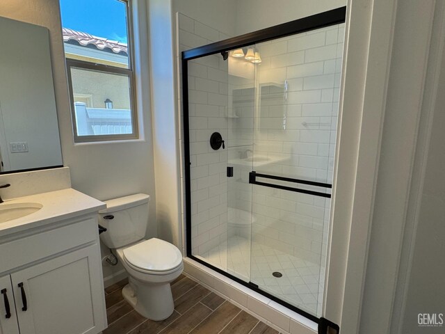 2411 Addlington St, Bakersfield, CA 93311 - full bathroom with wood finished floors, vanity, and a stall shower