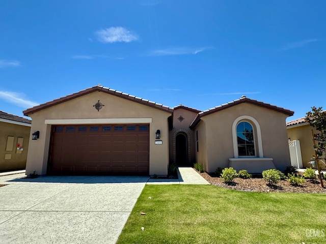 2411 Addlington St, Bakersfield, CA 93311 - mediterranean / spanish-style house with a garage, stucco siding, concrete driveway, and a front yard