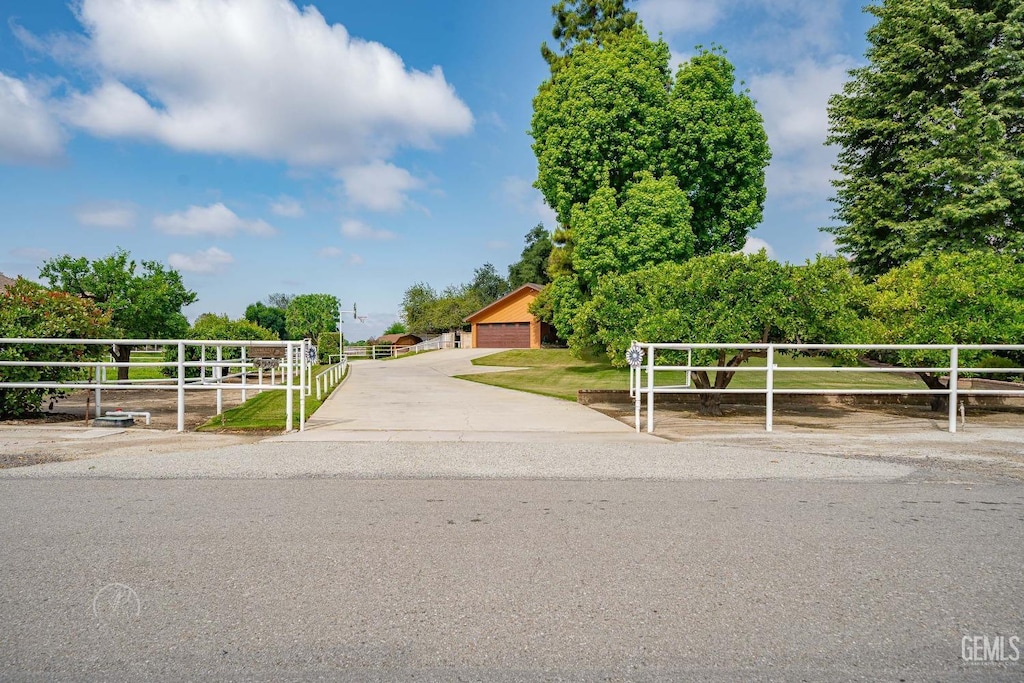 exterior space featuring a gate, fence, and a detached garage