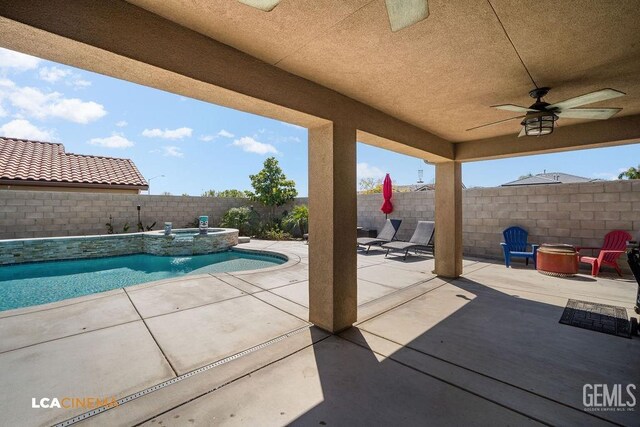 9311 Caliente Creek Ct, Bakersfield, CA 93311 - fenced backyard with an outdoor fire pit, ceiling fan, a patio, and a pool with connected hot tub