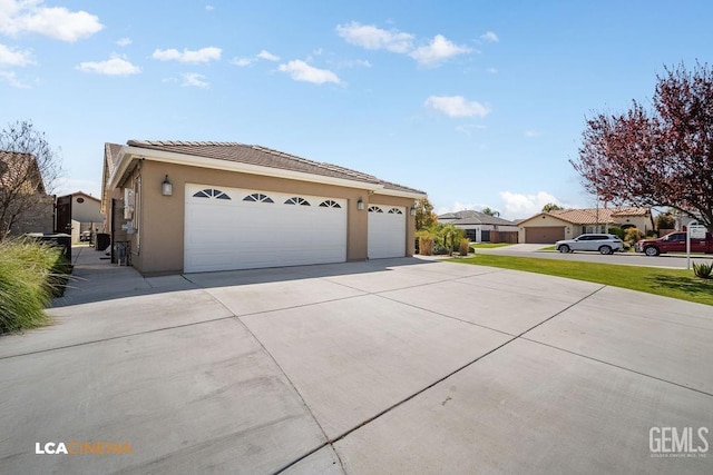 9311 Caliente Creek Ct, Bakersfield, CA 93311 - view of front of house featuring concrete driveway, stucco siding, a tiled roof, an attached garage, and a residential view