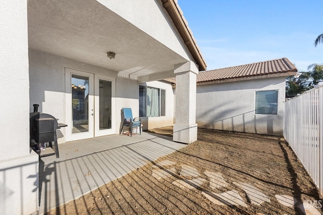 exterior space with a patio, french doors, grilling area, and fence