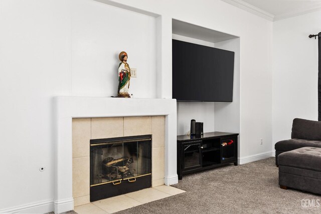 living room featuring ornamental molding, baseboards, light colored carpet, and a tiled fireplace