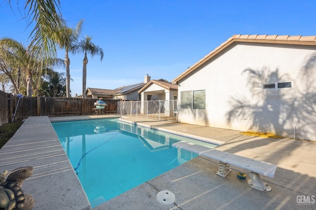 view of swimming pool with a fenced in pool, a fenced backyard, and a patio