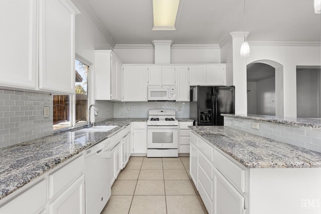 kitchen featuring decorative light fixtures, white cabinets, a sink, light tile patterned flooring, and white appliances