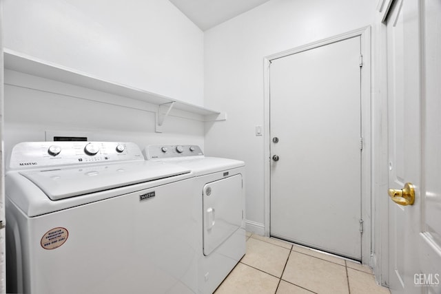 laundry area with light tile patterned floors, laundry area, and separate washer and dryer