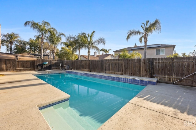 view of swimming pool featuring a fenced in pool, a patio area, and a fenced backyard