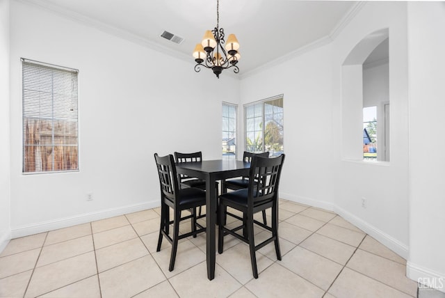 dining room with light tile patterned floors, visible vents, arched walkways, an inviting chandelier, and crown molding