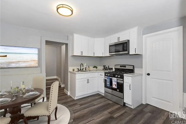 kitchen featuring sink, white cabinets, dark hardwood / wood-style floors, and appliances with stainless steel finishes