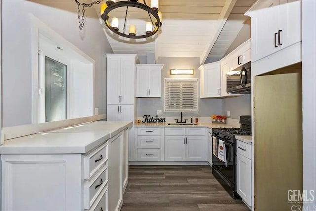 kitchen with white cabinets, sink, dark hardwood / wood-style floors, and black range with gas cooktop