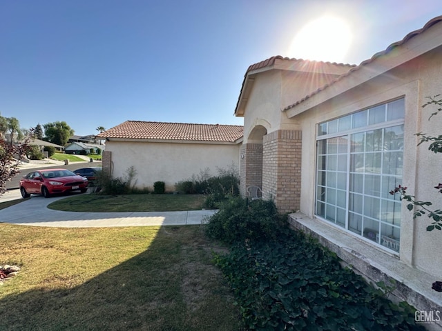 view of side of property with a lawn