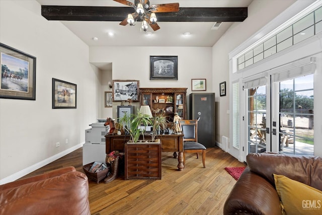 sitting room featuring beamed ceiling, ceiling fan, light hardwood / wood-style floors, and french doors