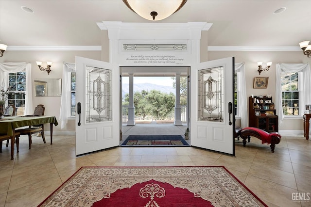 entrance foyer with light tile patterned floors and crown molding