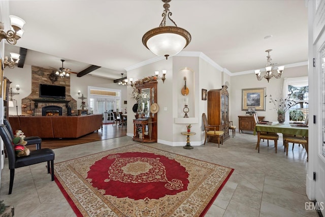 tiled entrance foyer with crown molding, a fireplace, a wealth of natural light, and a chandelier