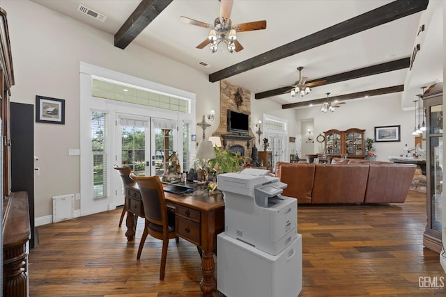 dining area with dark wood-type flooring, french doors, a stone fireplace, ceiling fan, and beamed ceiling