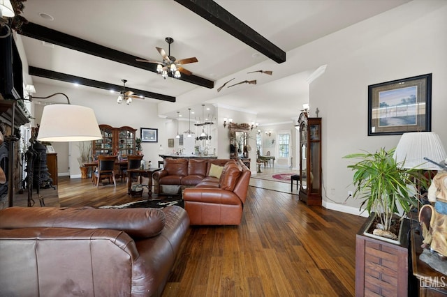 living room featuring beamed ceiling, dark hardwood / wood-style floors, ceiling fan, and crown molding