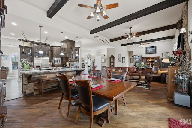 dining area featuring ceiling fan, beamed ceiling, and light wood-type flooring