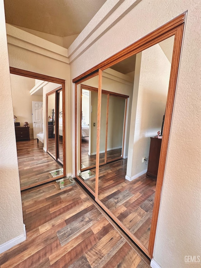 hallway with hardwood / wood-style floors