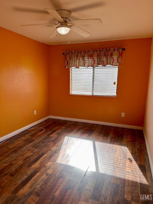 empty room featuring ceiling fan and hardwood / wood-style floors