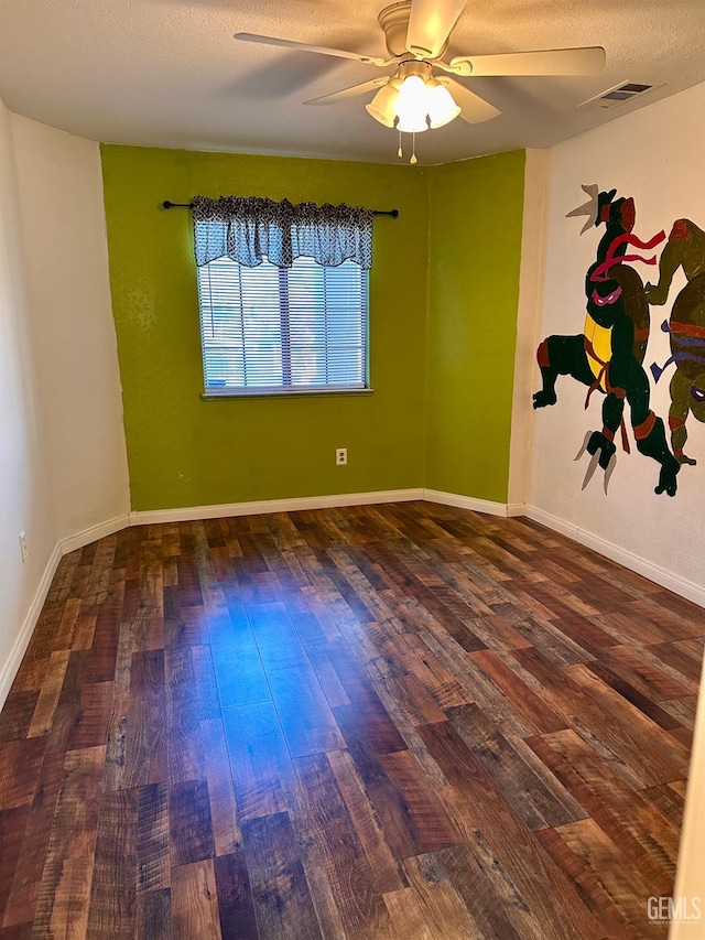 unfurnished room with ceiling fan, a textured ceiling, and dark hardwood / wood-style flooring