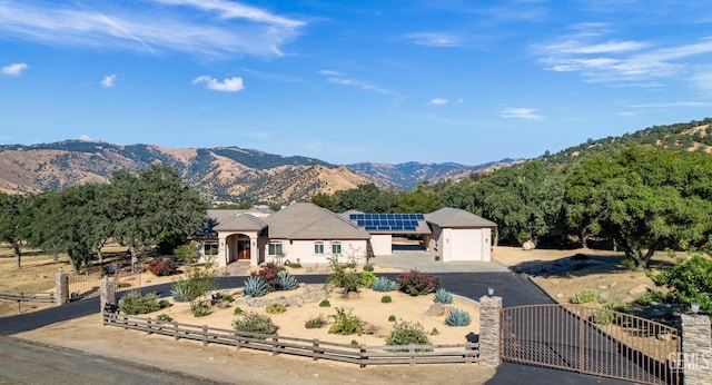 view of front of property with a mountain view and an outbuilding