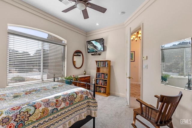 carpeted bedroom featuring ceiling fan, crown molding, and multiple windows