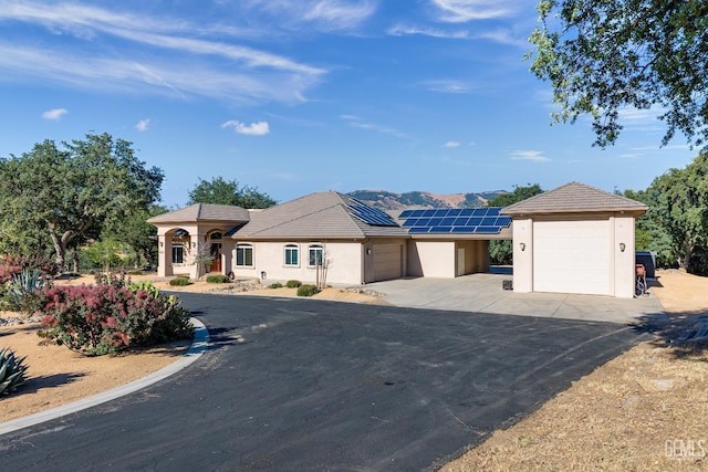 view of front of home featuring a garage and solar panels