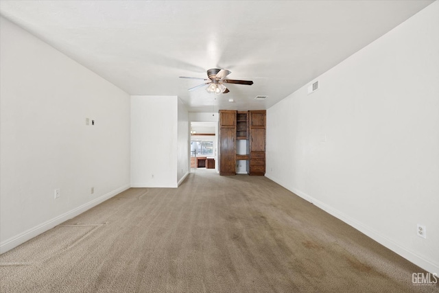 unfurnished living room featuring ceiling fan and light colored carpet