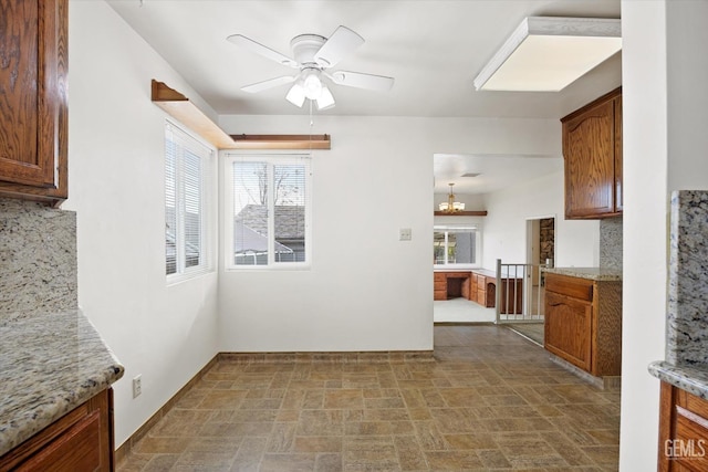 unfurnished dining area with ceiling fan and a healthy amount of sunlight