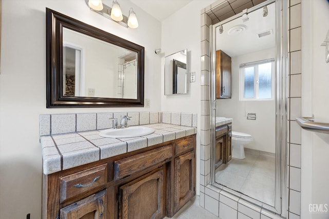 bathroom with vanity, an enclosed shower, tile patterned floors, and toilet