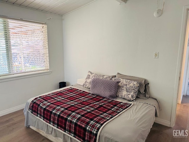 bedroom with baseboards and wood finished floors