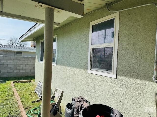 view of home's exterior featuring fence and stucco siding