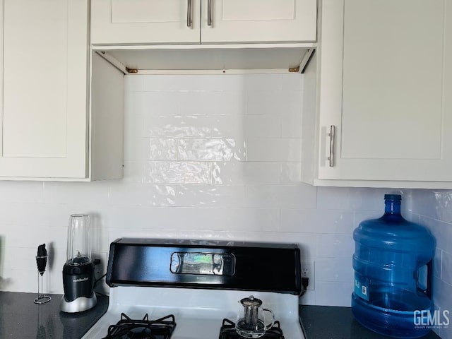 interior details with white cabinetry and stove