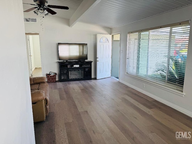 living area with wood finished floors, a glass covered fireplace, visible vents, and baseboards