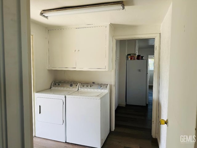 washroom featuring cabinet space and washing machine and clothes dryer