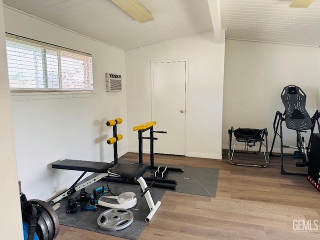 workout area featuring baseboards, wooden ceiling, wood finished floors, vaulted ceiling, and a wall mounted AC