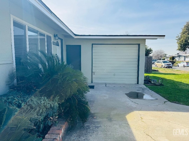 garage featuring concrete driveway