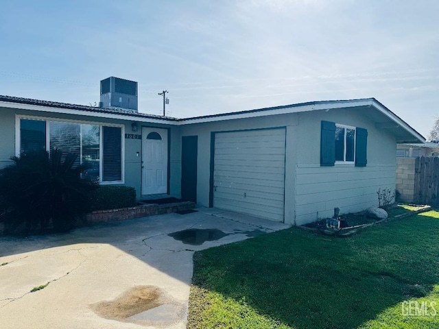 single story home with cooling unit, a garage, fence, driveway, and a front lawn