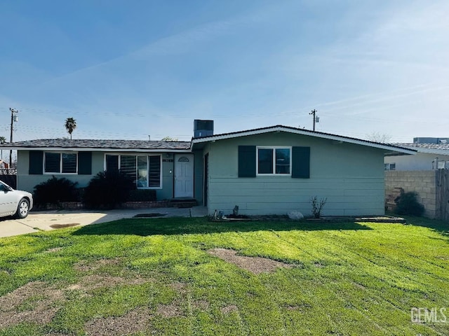 ranch-style home featuring a front yard and fence