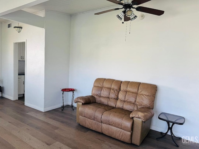 sitting room with a ceiling fan, visible vents, baseboards, and wood finished floors