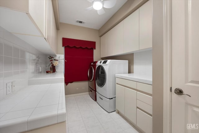 laundry area with cabinets, light tile patterned flooring, washer and clothes dryer, and ceiling fan