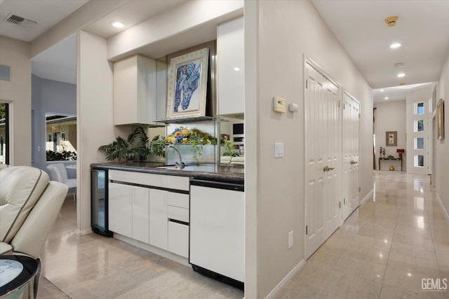 corridor featuring wine cooler and sink