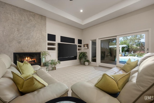 living room featuring built in shelves and a premium fireplace