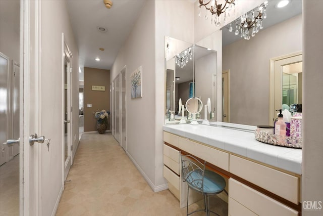 bathroom featuring a chandelier and vanity