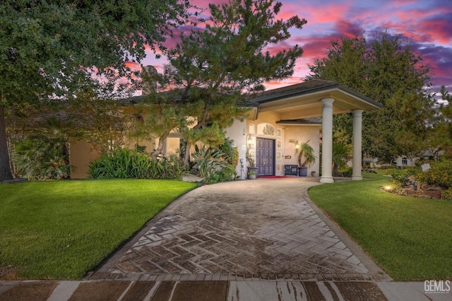 view of front of house with a yard