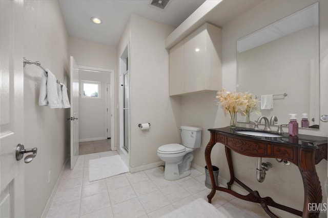 bathroom featuring tile patterned flooring, toilet, an enclosed shower, and sink