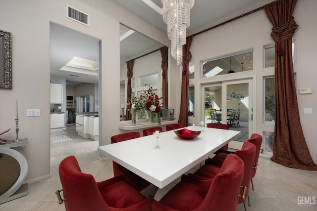 dining room featuring light tile patterned floors, an inviting chandelier, and french doors