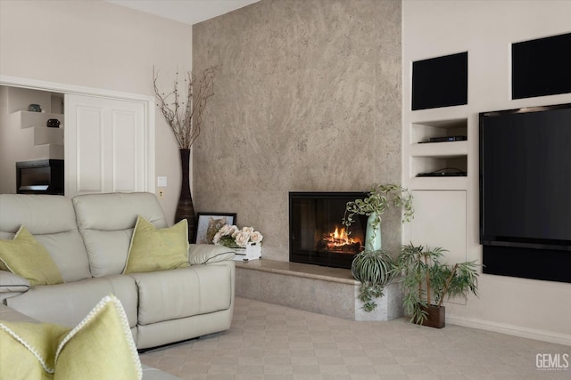 living room featuring a fireplace and built in features